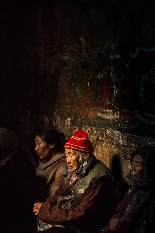 Buddhist women praying at a monastery located in Leh, India.