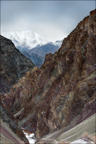 Clouds from an approaching storm begin to engulf the mountain peaks.